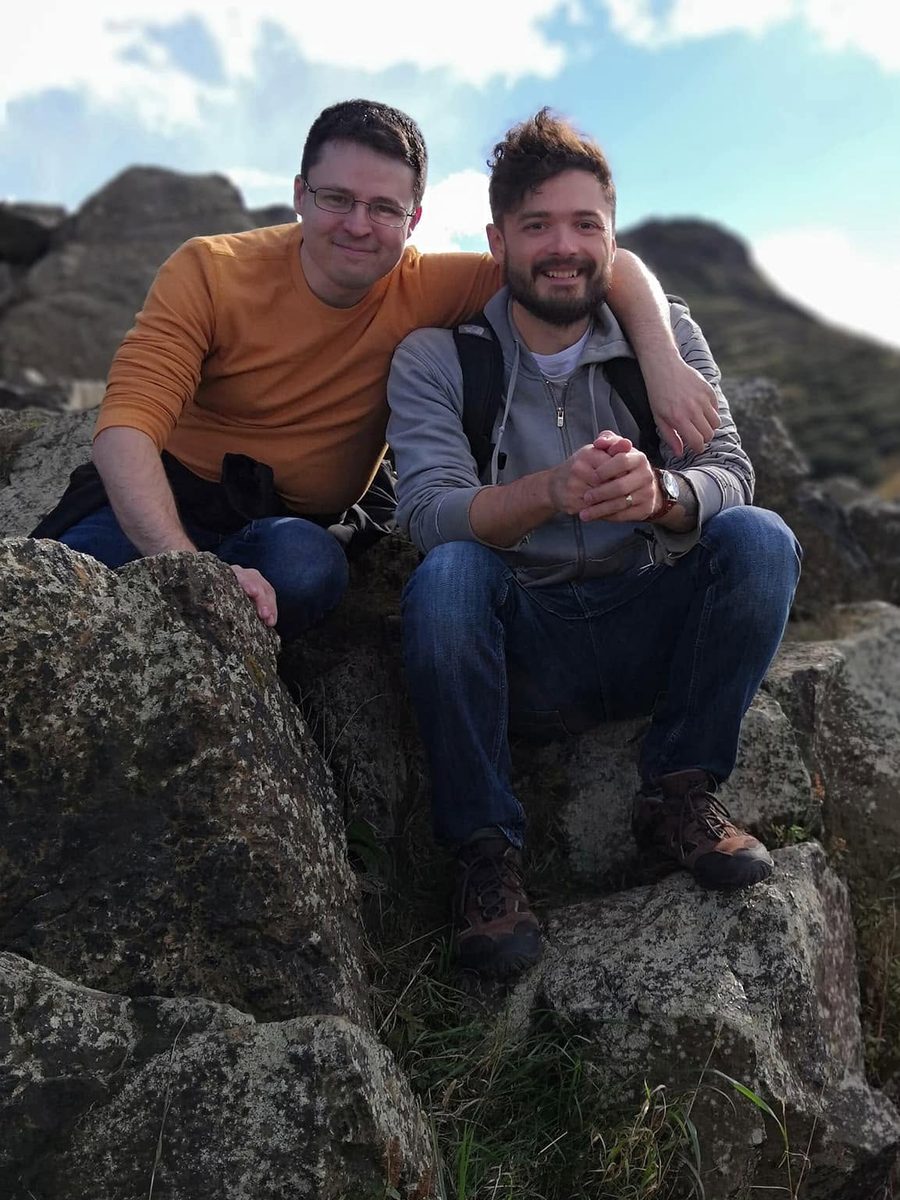 Jonathon and Joshua Janes sitting together on a rocky hillside